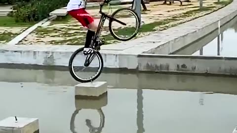 Bicyclists Jumps Over Water