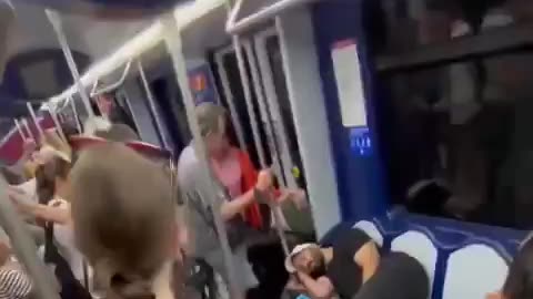 Muslim immigrant sleeps on 3 seats in Madrid metro. Old Spanish man waits