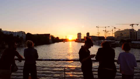 Tourists Overlooking Berlin Cityscape at Sunset