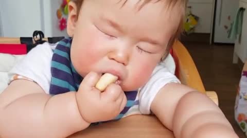 Baby literally falls asleep while eating snack