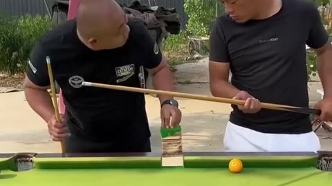 Funny people playing ball pool