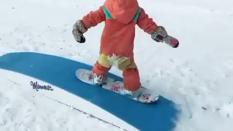 At only 4 years old, Emma is a talented snowboarder. 🏂