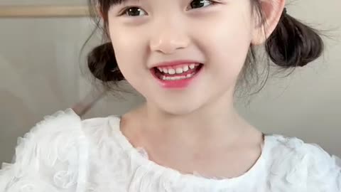 cute smiling baby girl in white dress