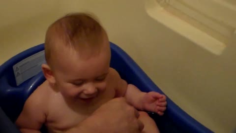 Little baby laughing in the water