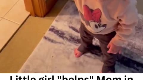 Toddler "helps" Mom in the bathroom.