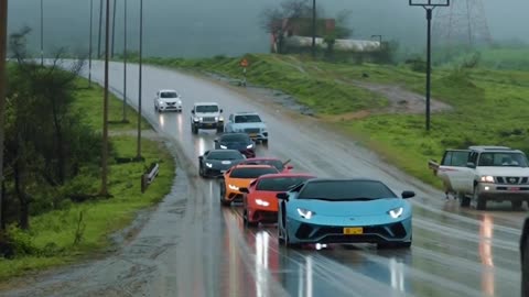 Parade of luxury cars under the divine rain