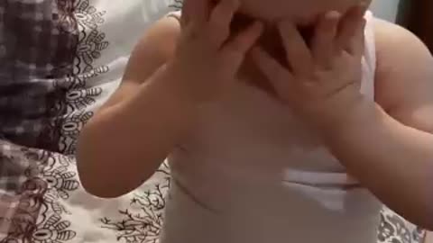 cute baby embarrassed by the camera