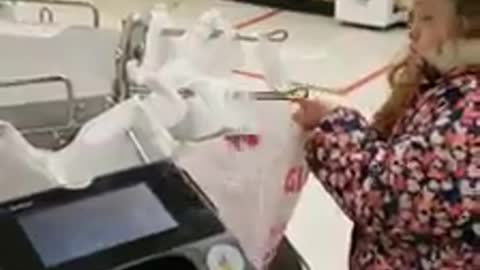 Young girl helps Giant grocery store worker bag groceries