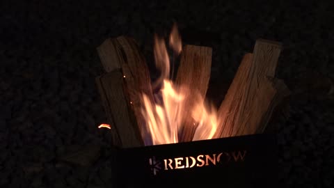 Wooden firewood burns brightly at the brazier