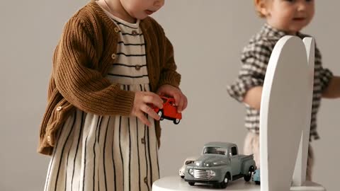 Little and Quite Baby Playing with her Car Toyes