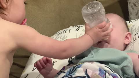 Big Sister Sends Bottle at Baby