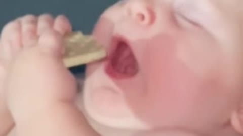 Cute Born Baby Eating Biscuit When He Sleeping