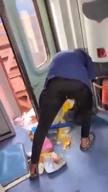 Railway worker dumping trash from a moving train