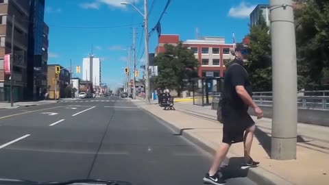 Guy blocks a car then walks into a pole