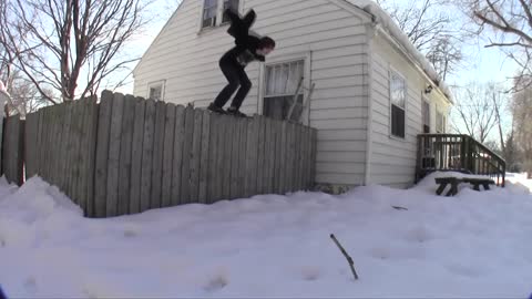 Guy flipping into snow from house