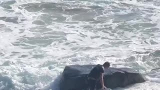 Surfer Struggles Against Pounding Waves