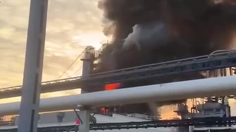 A Russian Fireman and his Pop-Up Desk Getting his Paperwork in Order as Oil Plant Burns(Omsk,Russia)