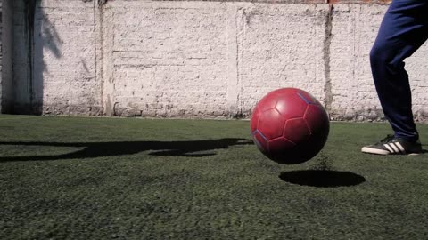 The feet of a two boys playing football soccer