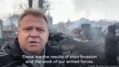 🇺🇸 VIDEO OF THE MAYOR OF BUCHA, SUBURBAN KYIV, SHOWING MILITARY VEHICLES BURNING ON THE ROAD