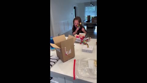 Little girl not too thrilled with exploding butterfly box