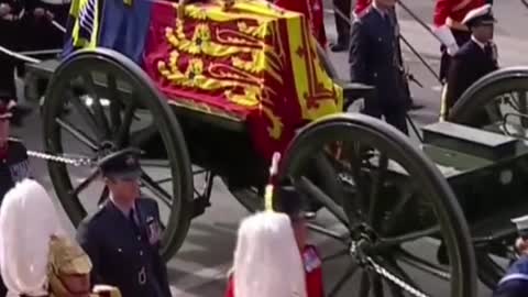 The public mourns as they watch Queen Elizabeth's coffin