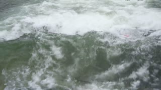 A man surfing the high waves