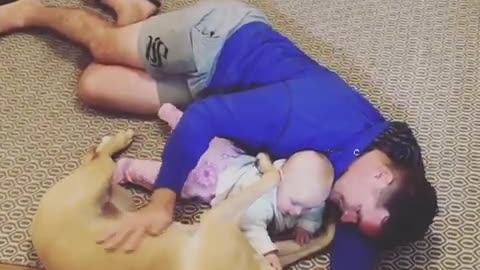 Dad, dog & baby preciously cuddle together