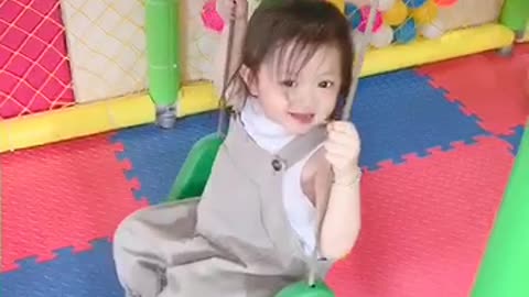 Cute baby playing swing game