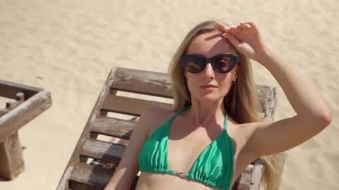 Woman Relaxing On Deck Chair |