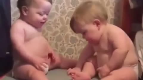 Cute action of 2 newborn babies