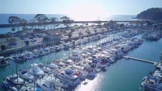 Morning at Harbor Viewed with Boats and Yachts while Two People Doing Kayaking