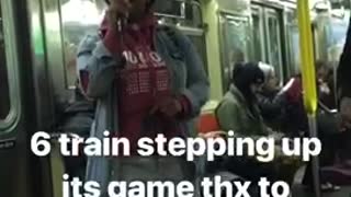 Woman in red hoodie sings beautifully on subway train, man plays red guitar