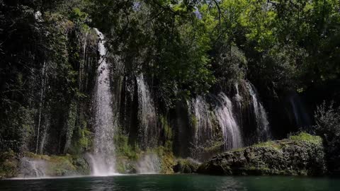 Waterfall with a small lake in the forest