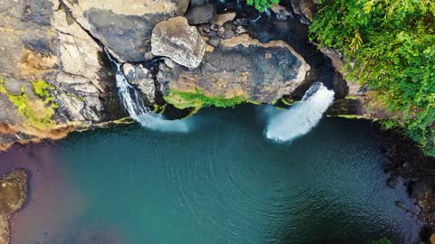 A Waterfalls Cascading From A Mountain Cliff