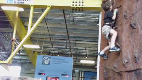 7 year old Joshua climbing rock wall.