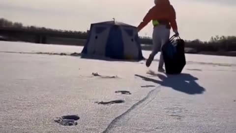 Girl fishing in a frozen pond