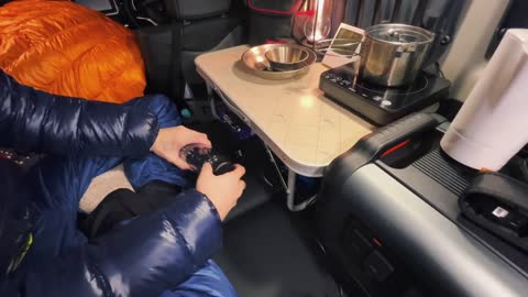 One person enjoys the self driving bread bed truck camping in the heavy snow