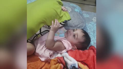 Beautiful cute baby eating pillow