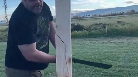 Man Chops Thick Piece of Wood With Custom Knife