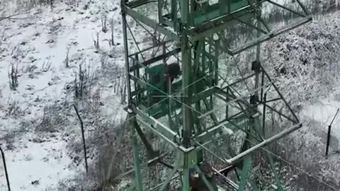 Ukrainians raise their flag on a watchtower outside of Kharkiv with the Russian border in sight