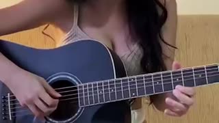 beautiful woman playing guitar