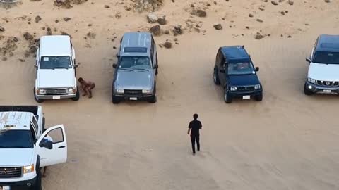 Amazing Racing diving cars in a sea of sand