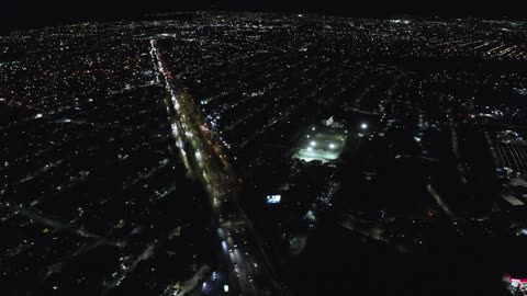 Large street passing through a city at night