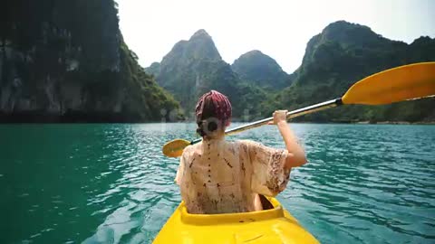 Woman kayaking in Halong Bay stock video