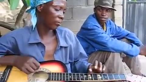 African old lady playing the guitar!!!