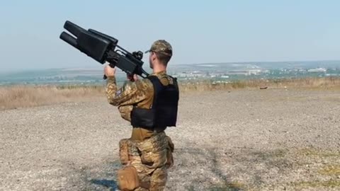 Ukraine War - A Ukrainian serviceman poses with EDM4S drone suppression system