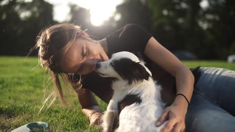 Smiling lady taking free time with her dog