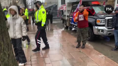 Police move through the peaceful freedom protest in Ottawa handing out notices to leave