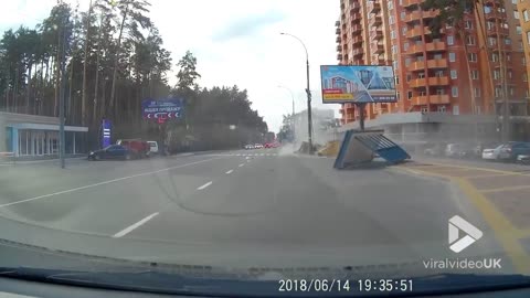 BMW slides and crashes into bus stop