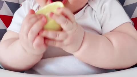 Baby tasting lemon for the first time